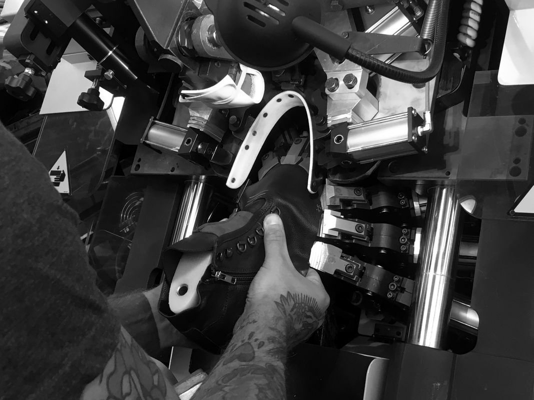 Shoe upper held in a lasting machine
