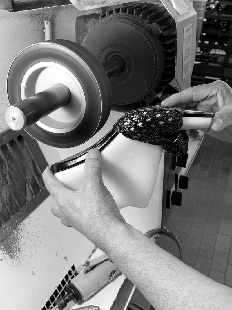 Finishing a polka-dot shoe at the polishing wheel