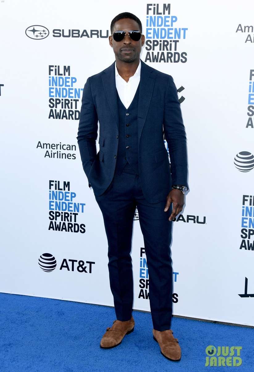 Guest in a navy three-piece suit and tan suede monk-strap shoes